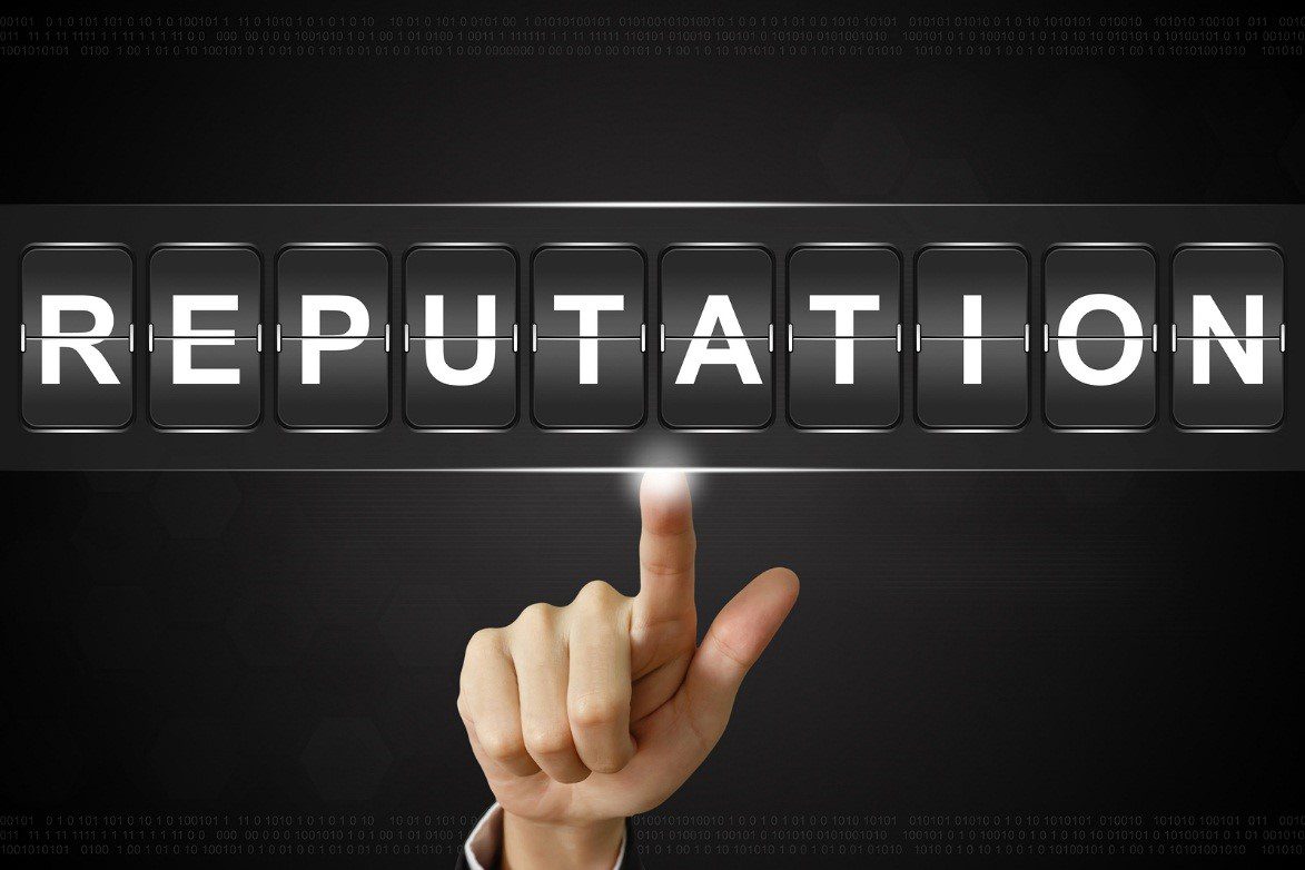 A hand points upward to a virtual flipboard displaying the word "REPUTATION" in illuminated white letters on a dark background.