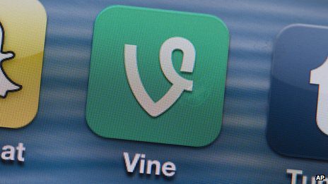 A close-up of the Vine app icon displayed on a smartphone screen, situated between the Snapchat and Tumblr app icons. The Vine icon is green with a stylized white "V.