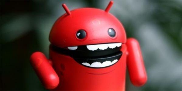 A red, cartoonish robot figure with antennae, large eyes, and a wide, toothy smile, resembling the Android mascot, against a blurred background.
