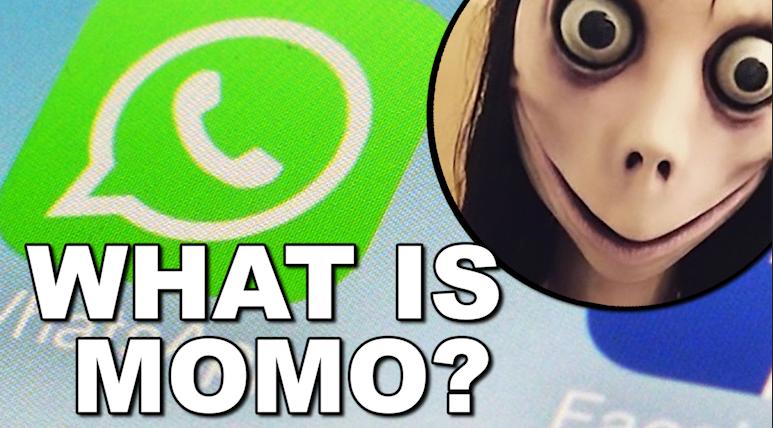 A WhatsApp logo appears in the background with bold text "WHAT IS MOMO?" in front. There is a circular inset showing a distorted, wide-eyed face commonly associated with the "Momo" internet challenge.