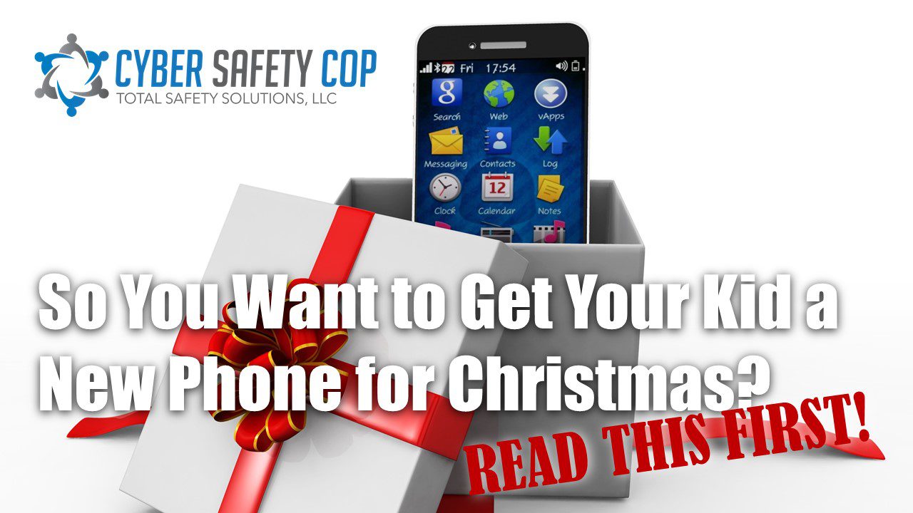 A smartphone in an open gift box with a red ribbon and bow. The text reads: "So You Want to Get Your Kid a New Phone for Christmas? READ THIS FIRST!" The Cyber Safety Cop logo is in the corner.