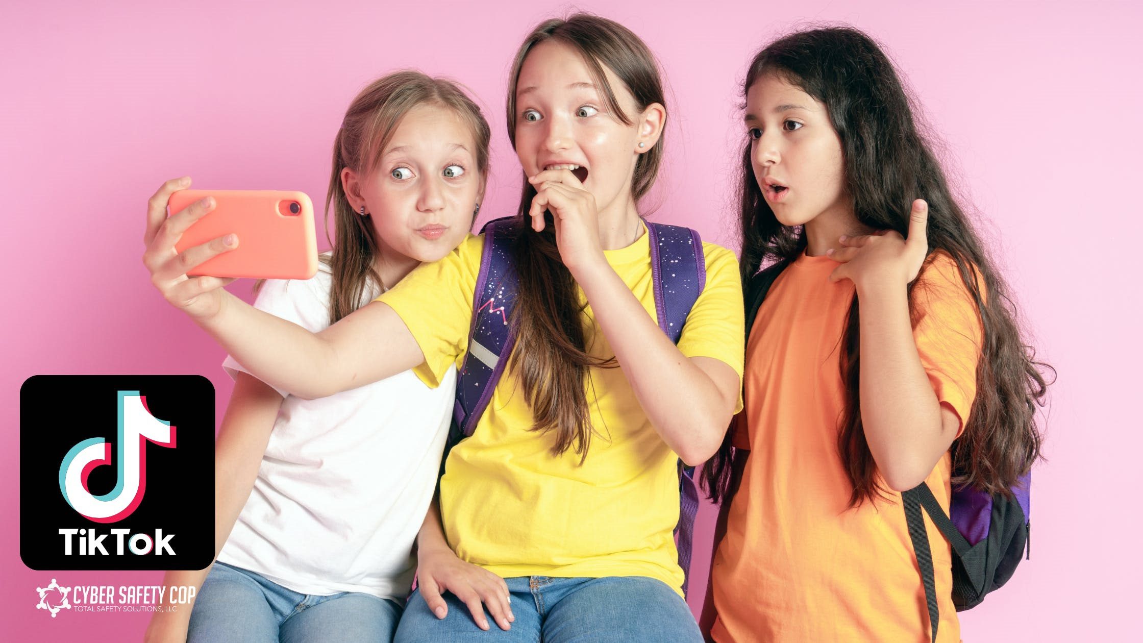 Three girls with backpacks take a selfie together, looking surprised and amused. They stand in front of a pink background. The TikTok logo and a “Cyber Safety Cop” badge appear in the corner.