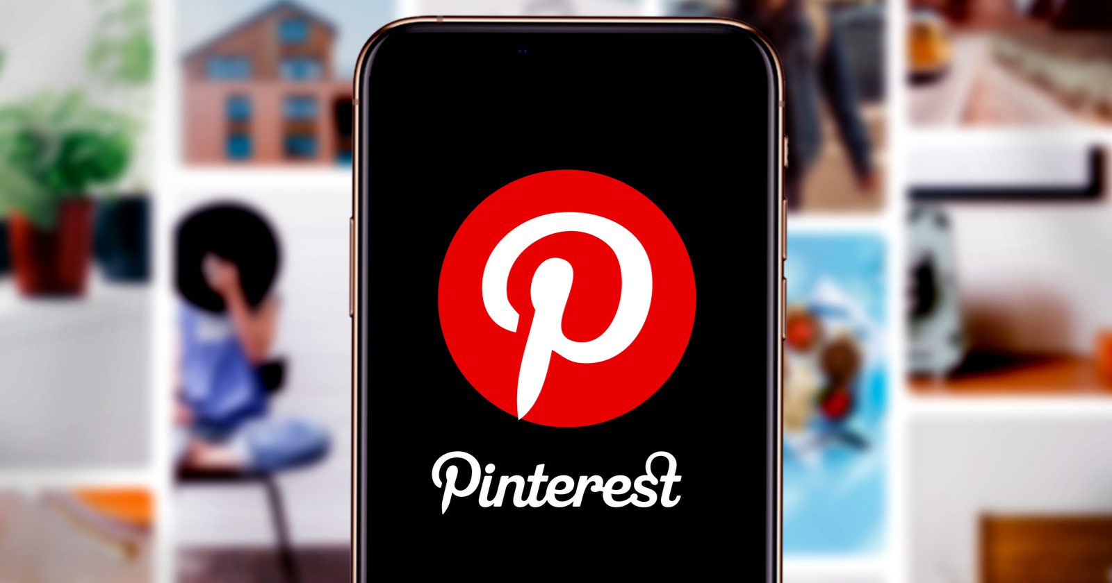 A smartphone displays the Pinterest logo on its screen, with a blurred background of colorful photos pinned on a wall.