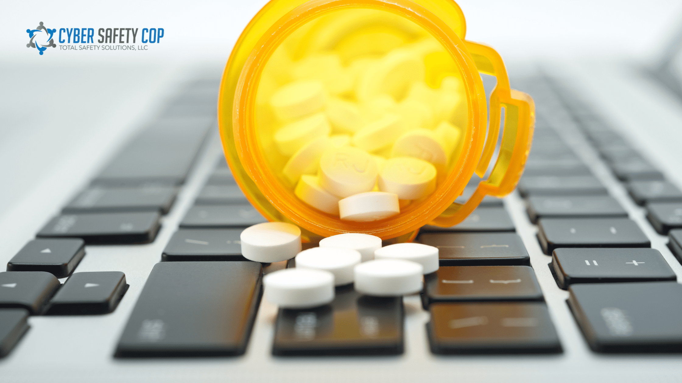 An orange pill bottle tipped over, spilling white tablets onto a computer keyboard. The Cyber Safety Cop logo appears in the upper left corner.