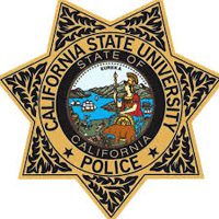 Gold star-shaped badge with black edges featuring "California State University Police" around the outer edge and the California state seal with a landscape and the word "Eureka" in the center.