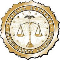 Gold and white seal featuring a balanced scale in the center, surrounded by the words "District Attorney Orange County California" in a circular design. Stars encircle the seal’s border.
