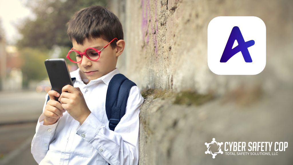 A young boy with red glasses and a backpack stands outside, leaning against a wall while using his smartphone on the Amino Fandoms App. The Amino app logo and Cyber Safety Cop logo appear on the image, highlighting safe online communities.