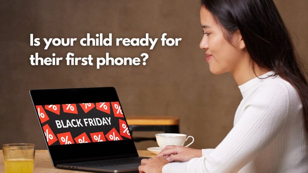 A woman sits at a table with a cup of coffee, looking at a laptop displaying a "Black Friday" sale banner. Text on the image reads, "Is your child ready for their first phone?.